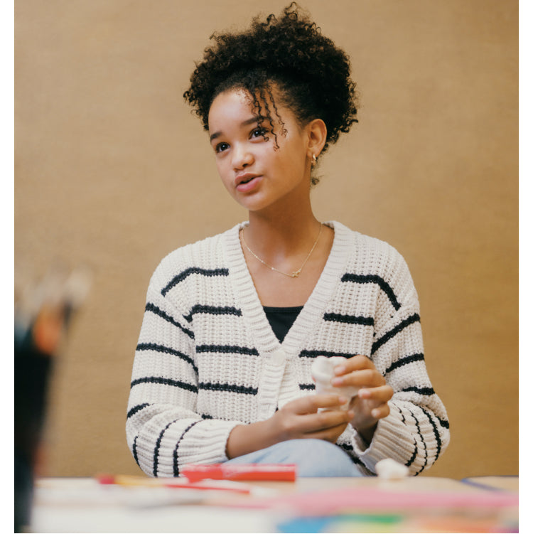 Girl working with art supplies.