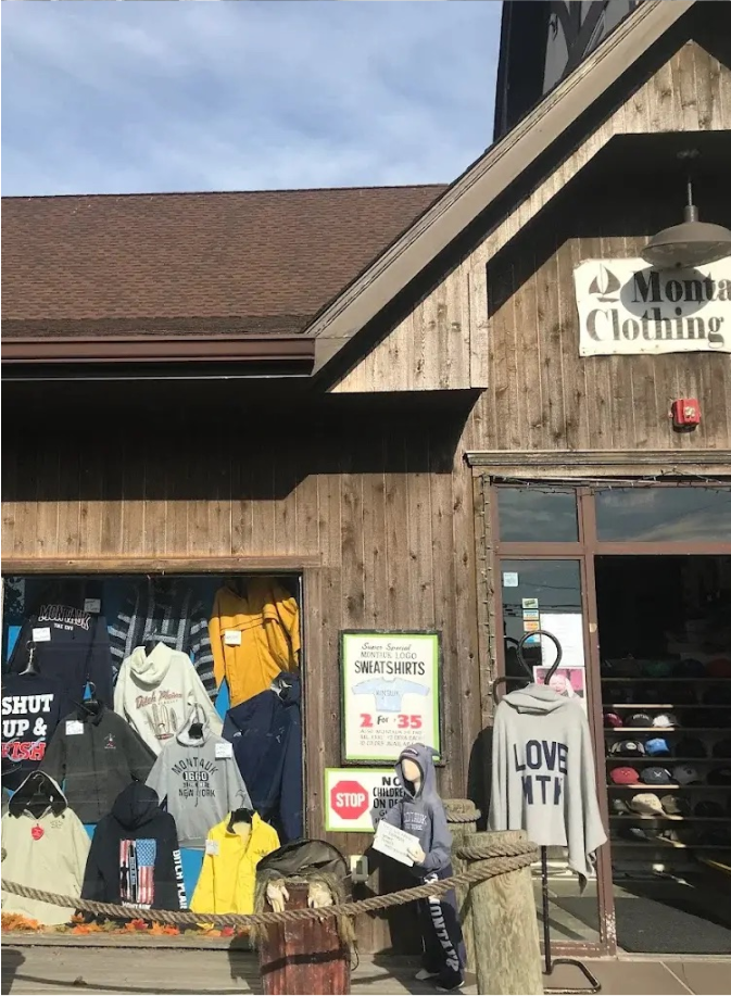A storefront with a window display full of t-shirts