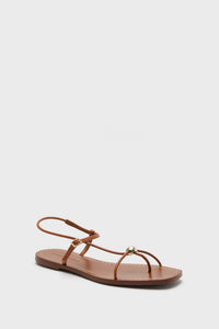 Loeffler Randall brown flat Timber Lara Sandals feature thin straps, a gold ball detail, and an ankle buckle.