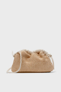 The Mansur Gavriel woven beige crossbody bag, inspired by the Natural Raffia Mini Cloud Clutch, features a drawstring closure and cream strap, offering understated elegance in luxury handbags.