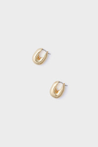 Pair of small, chunky gold-plated brass huggie hoops with a polished finish by Jenny Bird.
