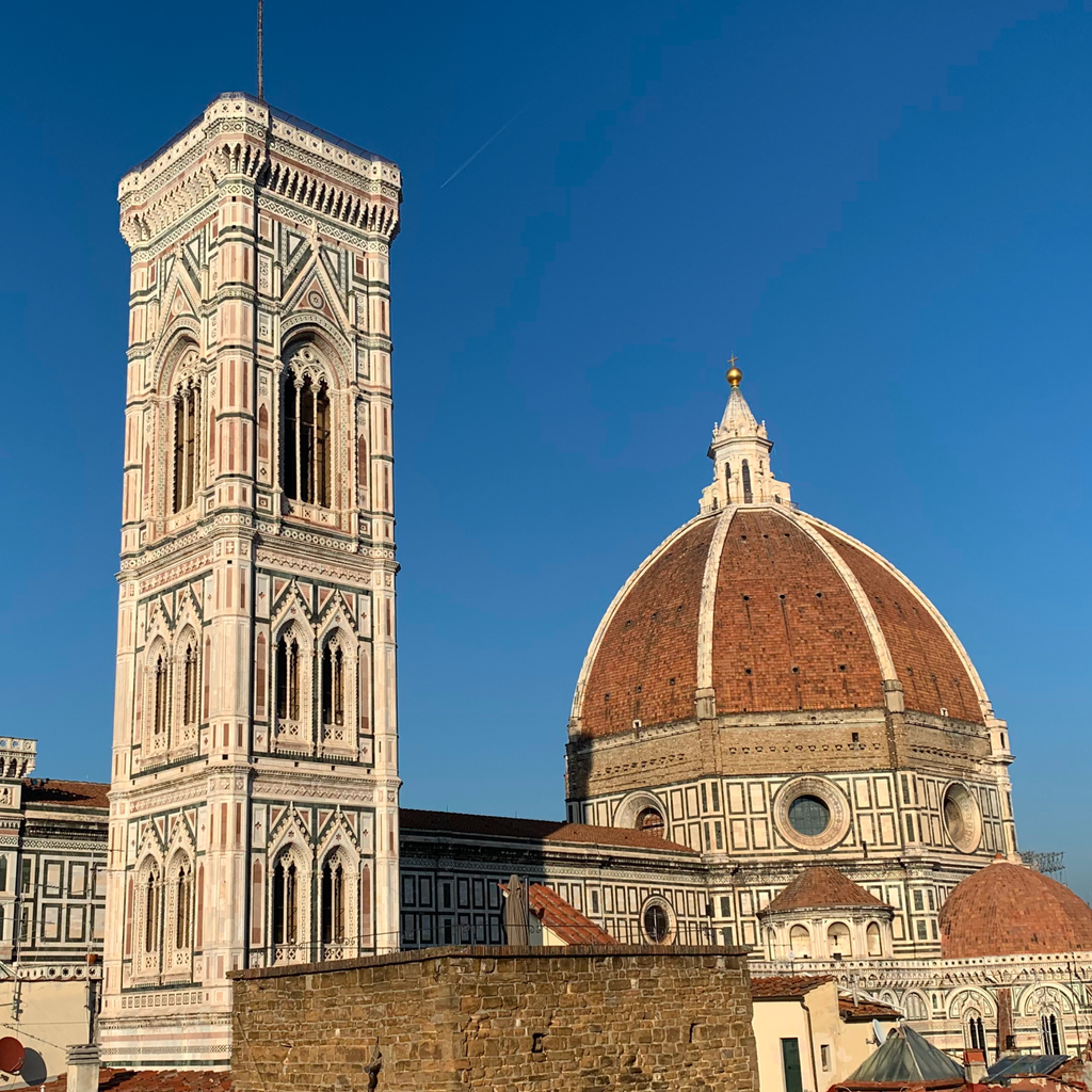 Classic view of Florence featuring Giotto’s Campanile and Brunelleschi’s Dome, epitomizing effortless elegance and high-end architectural beauty on a fun, clear day.