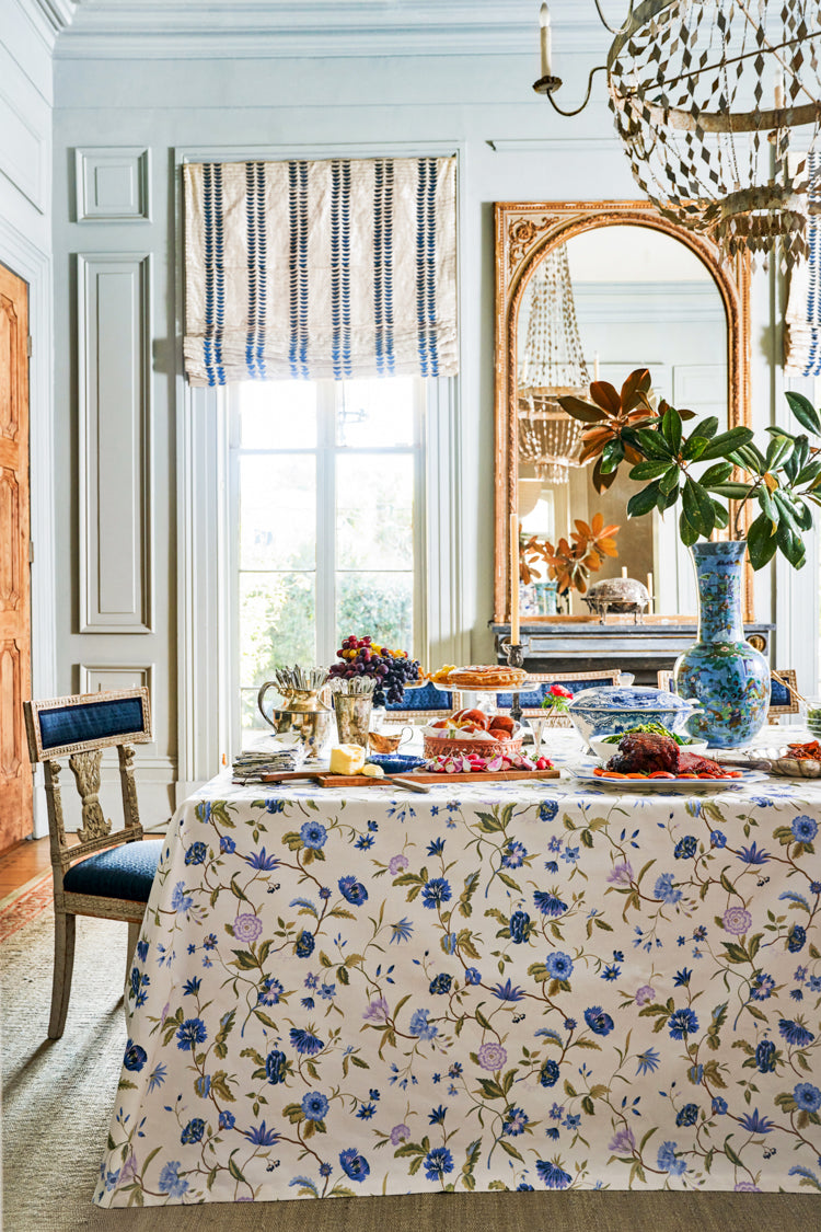 Classic dining room showcasing the Blue and Lavender Blossom Tablecloth, effortlessly draped with elegant dishes and decor, embodying a high-end, fun ambiance.
