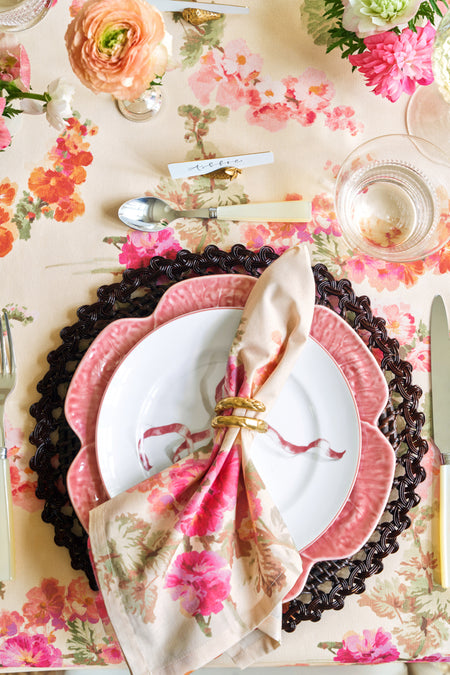 Gold Asparagus Napkin Rings Set of 4 on an elegant, floral-themed table setting with classic charm and effortless style, featuring high-end details like a woven charger plate and scalloped salad plate.