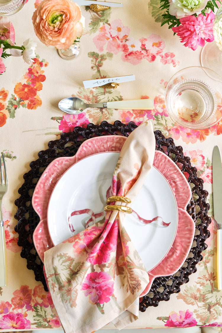 Gold Asparagus Napkin Rings Set of 4 on an elegant, floral-themed table setting with classic charm and effortless style, featuring high-end details like a woven charger plate and scalloped salad plate.