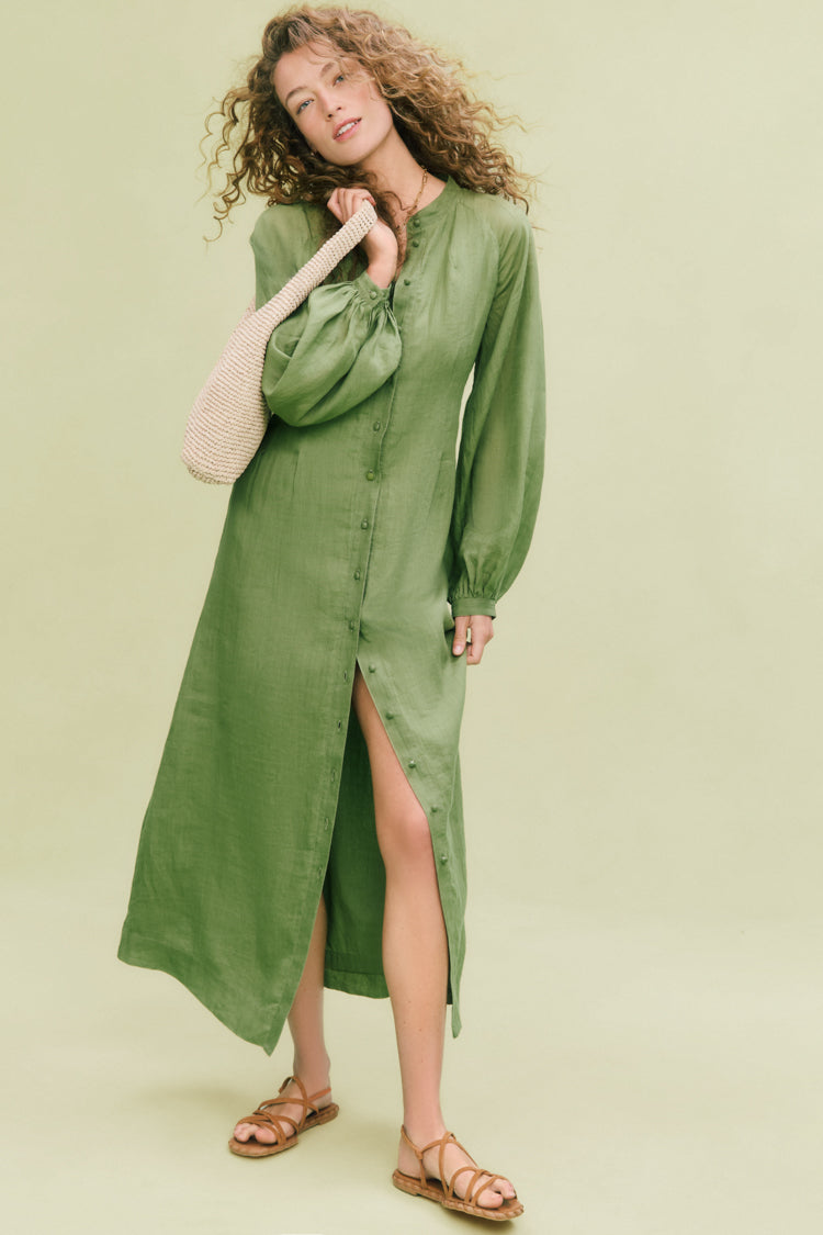 Young woman models the classic, effortless Cedar Green Button Down Granier Dress with a relaxed fit, billowy sleeves, and versatile styling for a fun, high-end look.