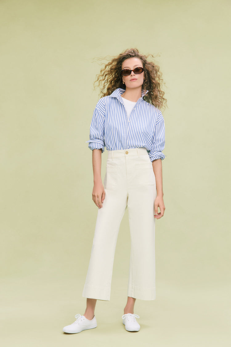 Woman wearing classic Stone Chino Wide Leg Davis Pants with scalloped pockets, paired effortlessly with a striped shirt, embodying a fun, high-end casual style.