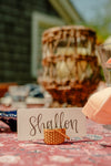A place card that says "shallon" and a basket place card holder. 