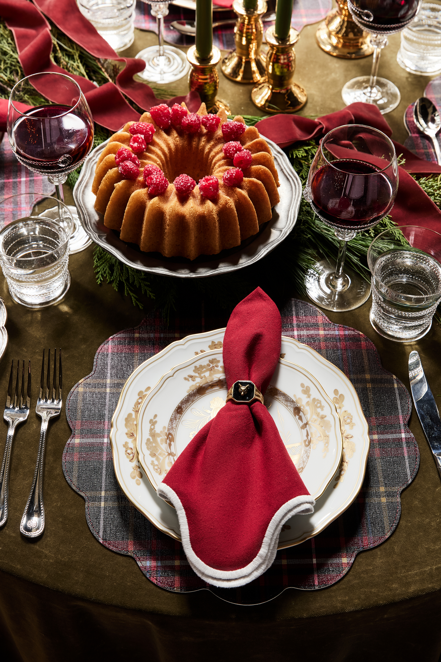 Cranberry and White Scalloped Napkins Set of 4, elegantly folded with contrast trim in a gold napkin ring, adding a classic, effortless touch to a high-end holiday table.