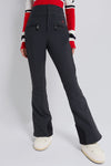 Black Aurora High Waist Ski Pant with classic, effortless fit and fun star-shaped zipper charms, modeled with off-white snow boots and striped sweater hem.