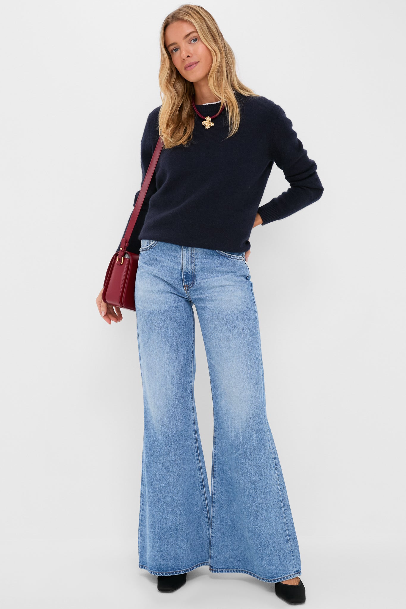 Woman wearing an effortless, classic look with wide-leg jeans and a Maroon Lelani Necklace, featuring removable gold heart and flower charms for versatile, high-end style.