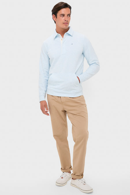 Man models the Heathered Ice Collared Sweatshirt with effortless style, featuring a classic collar, rugby details, and a kangaroo pocket, paired with chinos and sneakers.