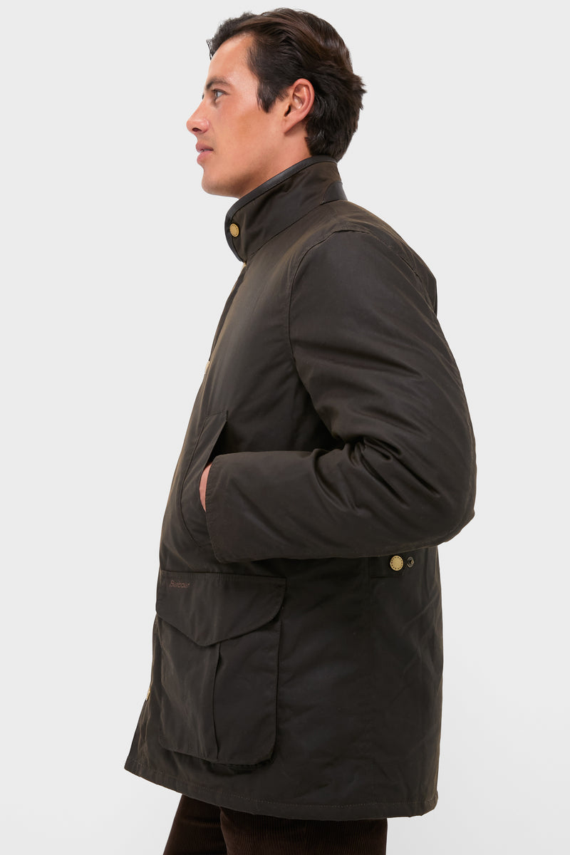 Man wearing Olive Hereford Wax Jacket, showcasing classic, high-end style with brass hardware and practical pockets, reflecting effortless and fun sophistication.