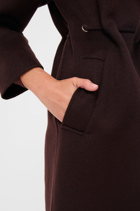 The Chocolate Kate Coat showcases a classic, effortless style with a wide V-collar, drawstring waist, and piped pockets, epitomizing high-end, fun fashion.