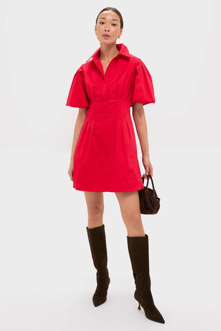 Model in Red Mini Delaney Dress with puff sleeves and collared neckline, styled with black knee-high boots and a dark brown handbag, showcasing an effortless, high-end, classic look.