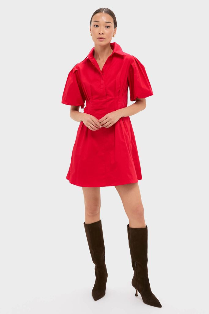 Red Mini Delaney Dress with classic spread collar, puff sleeves, and A-line skirt, paired with knee-high boots, showcasing an effortless, high-end style for fun occasions.