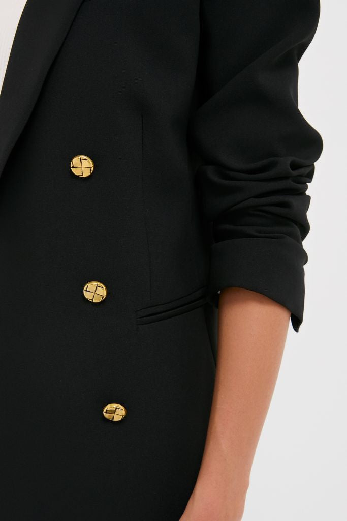 Person wearing the Black Diana Blazer, a classic, effortless double-breasted design with gold buttons and notched lapels, showcasing high-end style with a fun, modern twist.