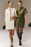 Two women in classic, chic attire, one wearing Black Transparent Matte Shaping Top 20 Tights, showcasing effortless, high-end style with fun, sophisticated details.