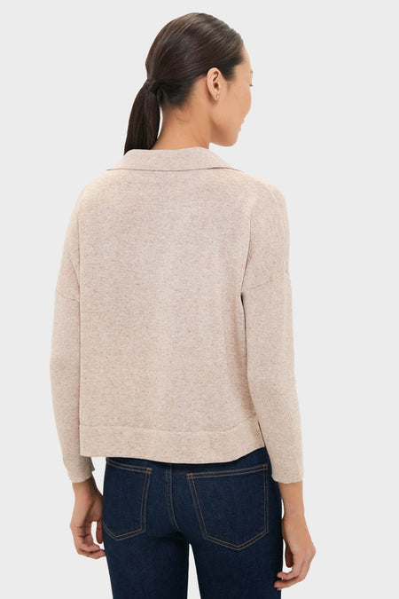 Woman wearing the Tan Clayton Long Sleeve Knit Polo, a classic, effortless knit with a spread collar and three-quarter sleeves, paired with dark denim. Perfect for a fun, high-end look.