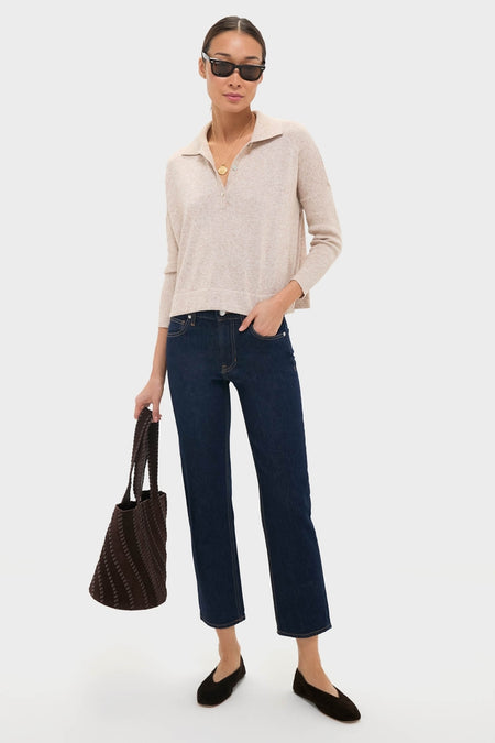 Woman wearing the Tan Clayton Long Sleeve Knit Polo, effortlessly styled with dark jeans and flats, exuding a classic, high-end, and fun vibe, holding a chic tote.