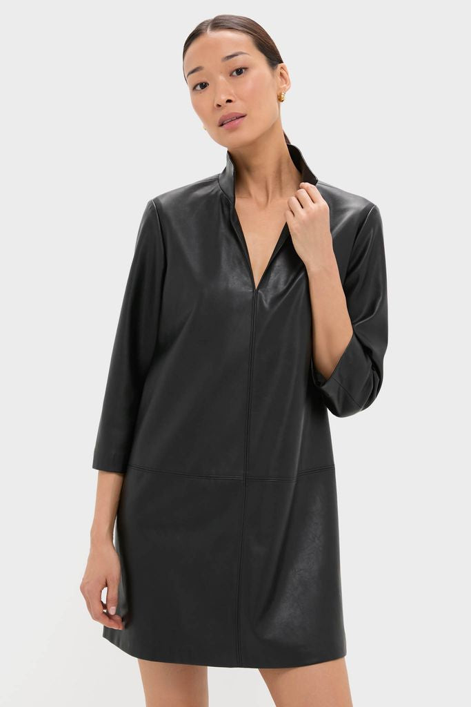 Woman modeling the Black Leather Clifton Dress, a classic, effortless A-line mini with V-neck and stand collar, perfect for high-end, fun, versatile style.