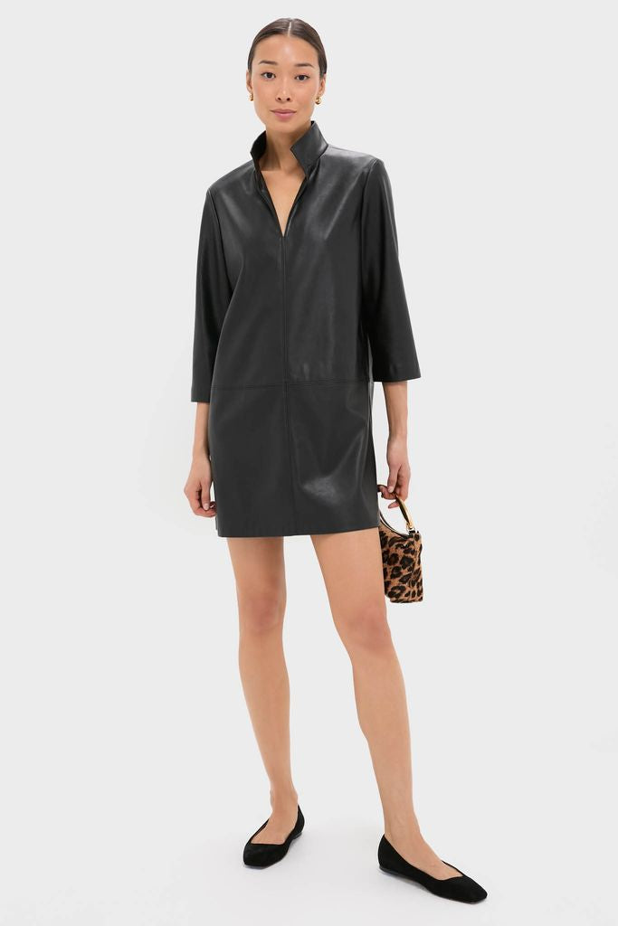 Model in Black Leather Clifton Dress, featuring a classic, effortless design with a stand collar, V-neck, and three-quarter sleeves, paired with ballet flats and a leopard-print bag.