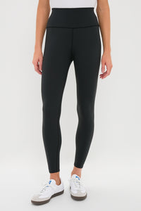 Classic Black High Rise Compression Spandex MacKenzie Legging paired with white sneakers, showcasing an effortless and flattering fit, perfect for fun, high-end activities.