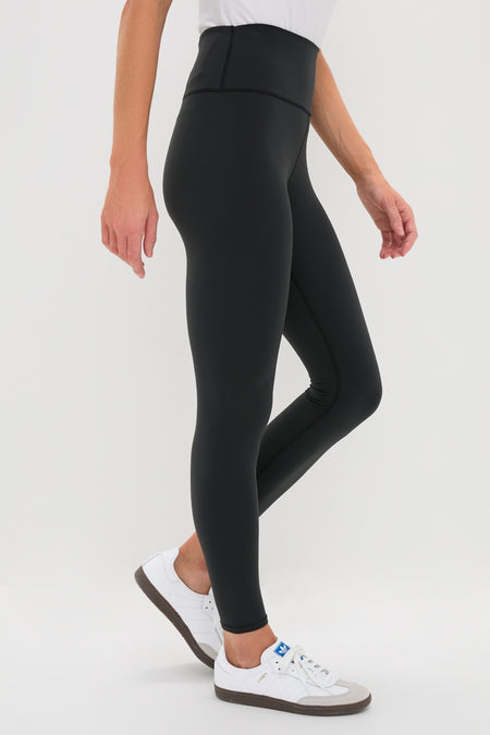 Classic Black High Rise Compression Spandex MacKenzie Legging, effortlessly styled with white sneakers, offering a flattering fit and high-end, fun versatility for any occasion.