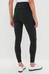 Classic Black High Rise Compression Spandex MacKenzie Legging showcased with effortless style, paired with white sneakers, embodying a fun and high-end look for versatile wear.