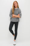 Woman in a grey sweater and white sneakers effortlessly models Black High Rise Compression Spandex MacKenzie Legging, showcasing its classic, flattering fit and high-end style.