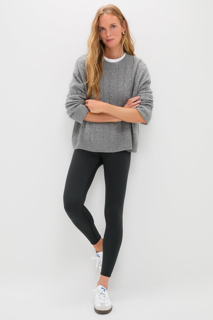 Woman in a grey sweater and white sneakers effortlessly models Black High Rise Compression Spandex MacKenzie Legging, showcasing its classic, flattering fit and high-end style.