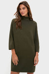 Woman wearing the Moss Green Vivianne Dress; an effortless, classic sweater dress with three-quarter sleeves and a mock turtleneck, exuding fun sophistication and high-end style.