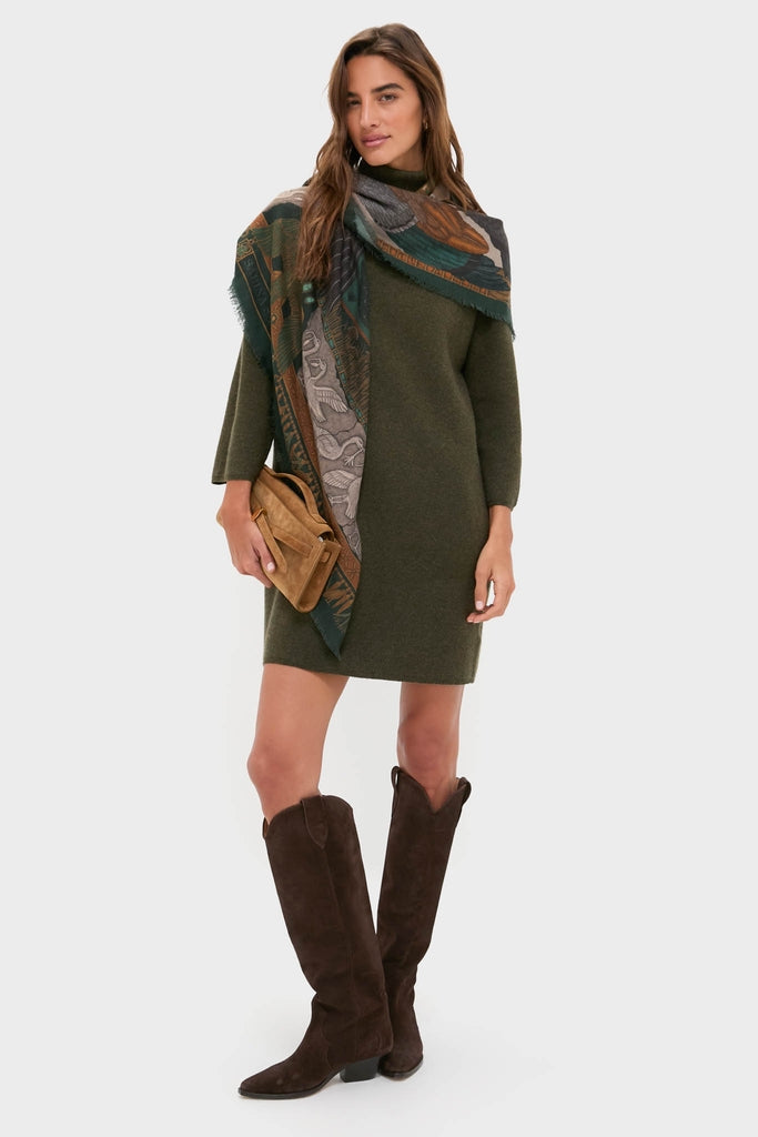 Model in classic, olive-green Moss Green Vivianne Dress and fringed scarf, paired with dark suede boots and tan crossbody, exuding effortless, high-end style.