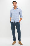 Man wearing Blue Nights Coastline Chino, showcasing classic, effortless style with rolled-up sleeves and tan Chelsea boots, embodying high-end, fun, everyday versatility.