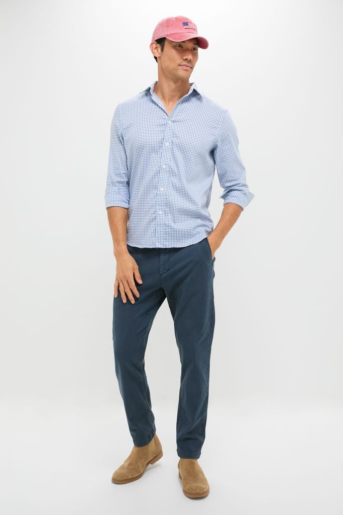 Young man wears classic Blue Nights Coastline Chino with effortless style, paired with a gingham shirt and Chelsea boots, capturing a fun, high-end casual look.