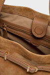 Camel Cleo Suede Tote interior with gold zip pocket, magnetic snap tab, and leather tag. A classic, high-end choice for effortless style and fun sophistication.