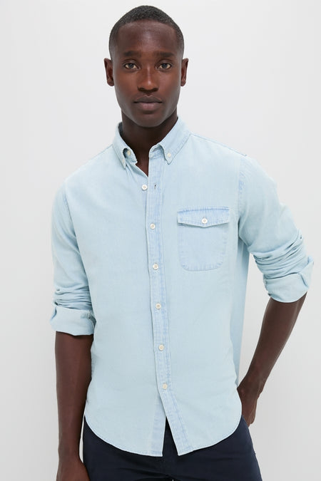 Man wearing a classic Light Blue Washed Denim Shirt with rolled sleeves and a chest pocket, evoking an effortless, high-end, and fun Americana style.