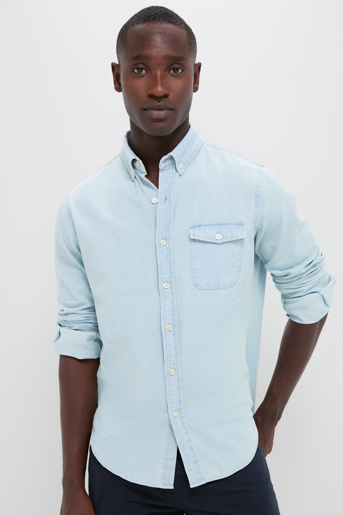 Man wearing a classic Light Blue Washed Denim Shirt with rolled sleeves and a chest pocket, evoking an effortless, high-end, and fun Americana style.