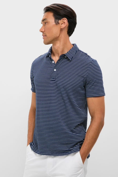 Young man wearing a classic, high-end Striped Navy Stretch Linen Polo, effortlessly styled with white pants, exuding a fun and confident vibe.