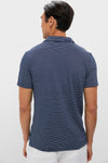 Man wearing a classic Striped Navy Stretch Linen Polo, showcasing effortless style with its breathable fabric and high-end design, perfect for fun, versatile occasions.