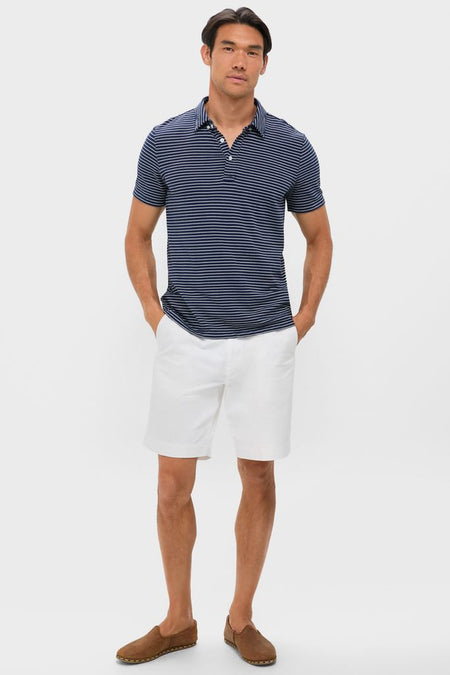 Male model in a classic Striped Navy Stretch Linen Polo, effortlessly styled with white shorts and brown loafers, capturing a high-end, fun, and versatile summer look.