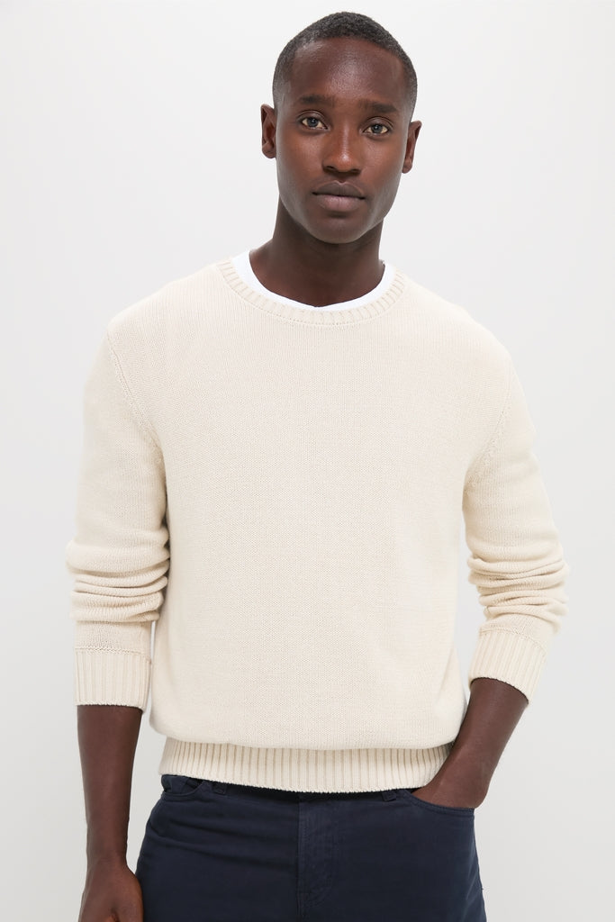 Young man wearing the Light Tan All Season Classic Crewneck, exuding classic, effortless style with its soft, textured knit, embodying high-end vintage inspiration for versatile, year-round wear.