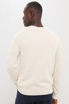 Man in Light Tan All Season Classic Crewneck with textured knit, showcasing ribbed hem and cuffs, embodying an effortless, classic, and high-end style.