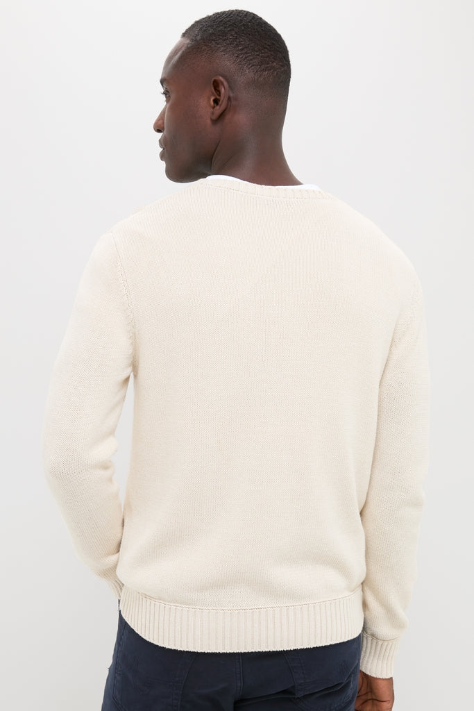 Man in Light Tan All Season Classic Crewneck with textured knit, showcasing ribbed hem and cuffs, embodying an effortless, classic, and high-end style.