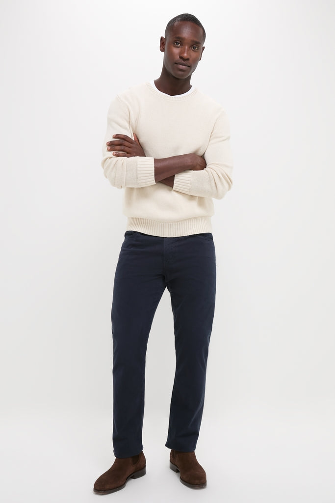 Young man models the Light Tan All Season Classic Crewneck, showcasing its classic, effortless style with textured knit and contrasting hem, embodying high-end vintage inspiration for versatile wear.