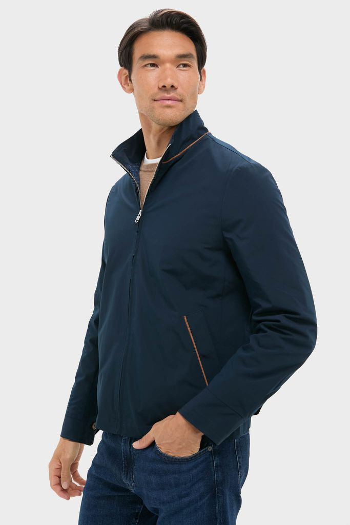 Male model in Navy Blue Stanley Jacket, effortlessly stylish with suede-trimmed pockets, paired with jeans. A classic, high-end piece blending fun and modern design.