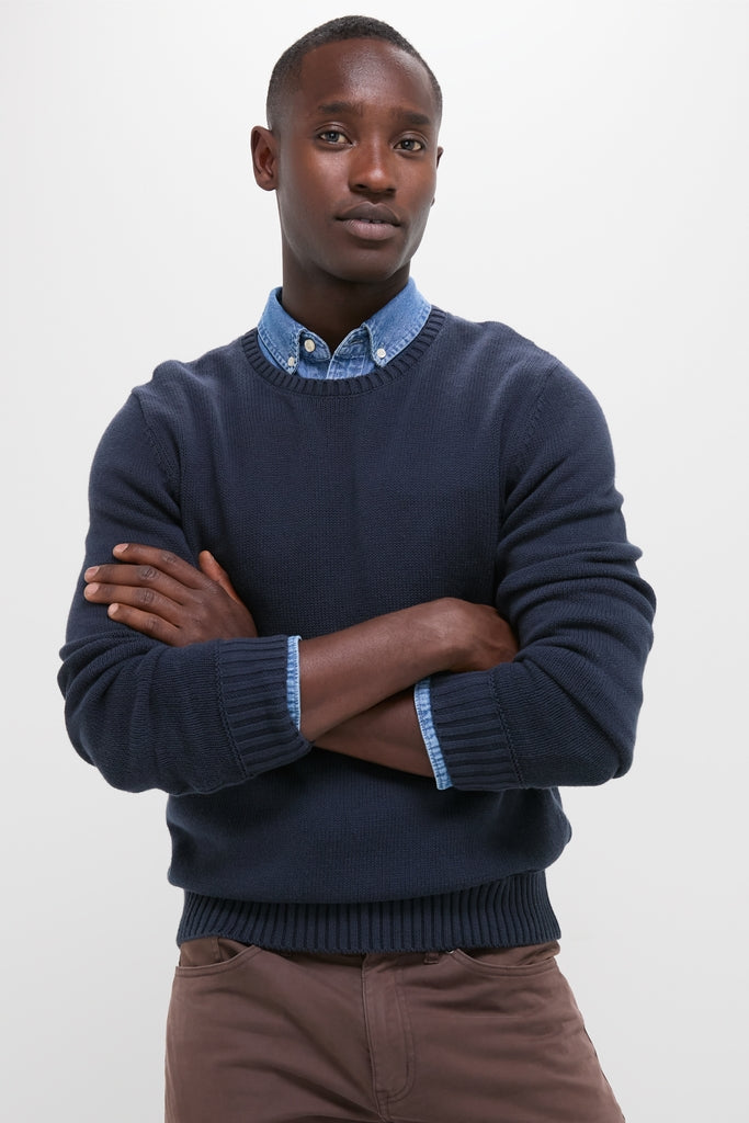 Young man models the Navy Blue All Season Classic Crewneck, showcasing its effortless, high-end classic design with textured knit, ideal for fun, versatile year-round wear.