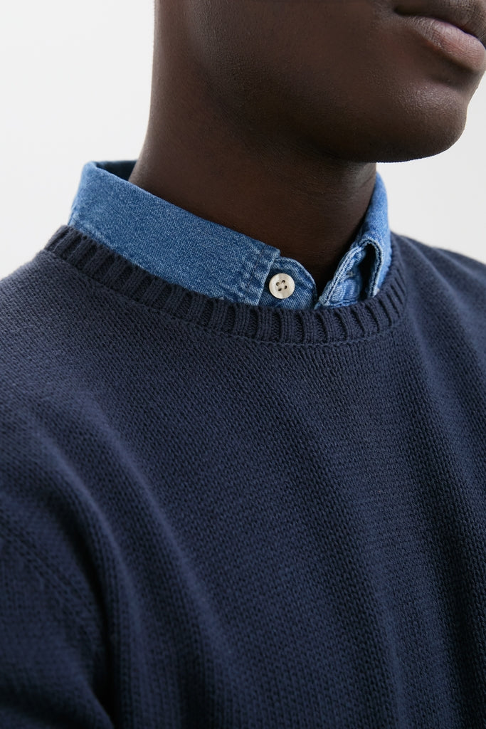 Navy Blue All Season Classic Crewneck over a denim shirt, showcasing an effortless, high-end look. Perfect for fun, classic, year-round style.