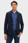 Navy Blue Knit Travel Blazer on mannequin, styled with a blue gingham shirt and jeans. Classic, effortless design perfect for high-end, fun travel or business occasions.