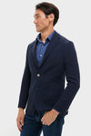 Classic and effortless, the Navy Blue Knit Travel Blazer offers a wrinkle-resistant design, perfect for travel, styled with a check shirt and jeans for a fun, high-end look.
